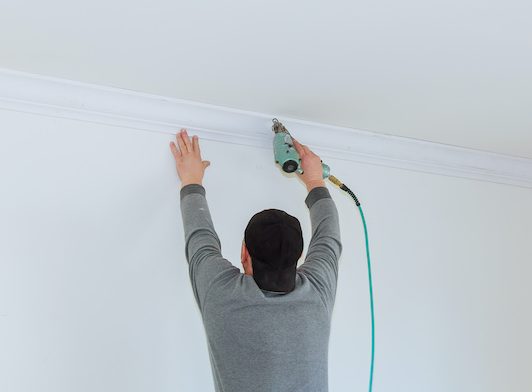man installing crown molding